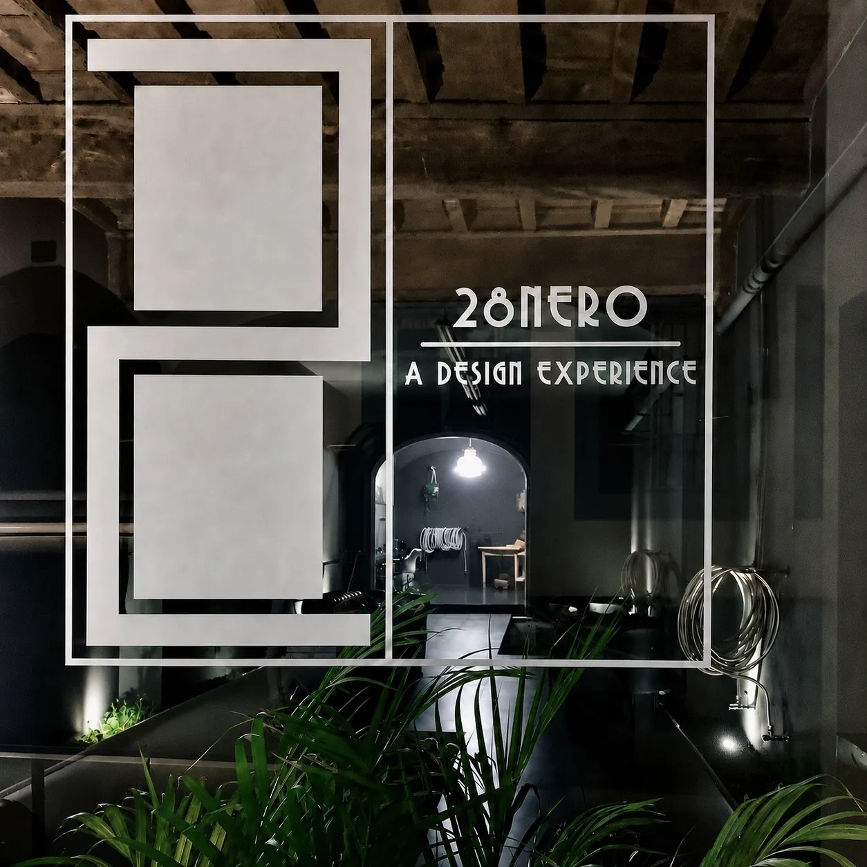 The 28nero decal on the atelier window at night